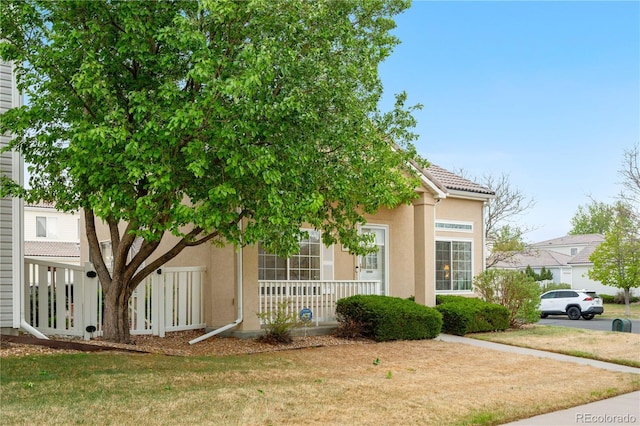 20835 E 47th Ave, Denver, CO 80249 - view of front of home with stucco siding and a front yard