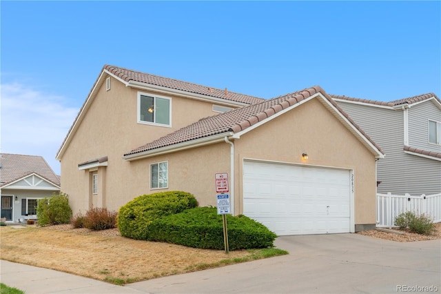 20835 E 47th Ave, Denver, CO 80249 - view of front of property featuring driveway, fence, a garage, stucco siding, and a tile roof