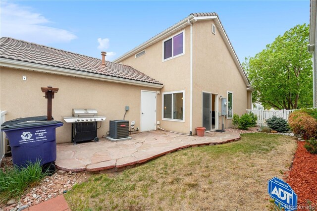 20835 E 47th Ave, Denver, CO 80249 - rear view of house with fence, central AC, a patio, stucco siding, and a tiled roof