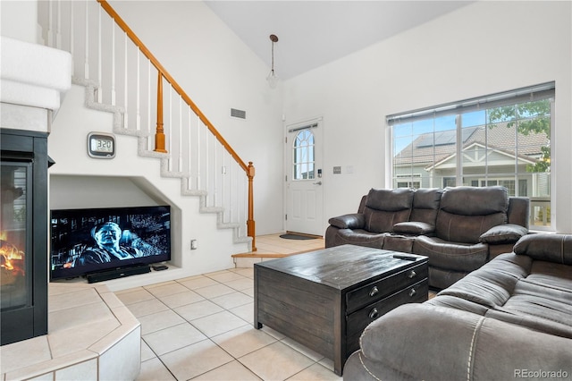 20835 E 47th Ave, Denver, CO 80249 - living room featuring visible vents, high vaulted ceiling, light tile patterned flooring, and plenty of natural light