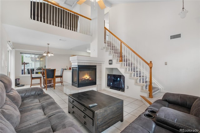 20835 E 47th Ave, Denver, CO 80249 - living room with ceiling fan with notable chandelier, a towering ceiling, visible vents, stairway, and tile patterned flooring