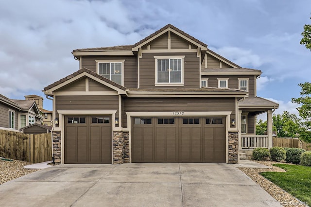 12578 Hudson Ct, Thornton, CO 80241 - view of front facade with an attached garage, stone siding, driveway, and a tile roof