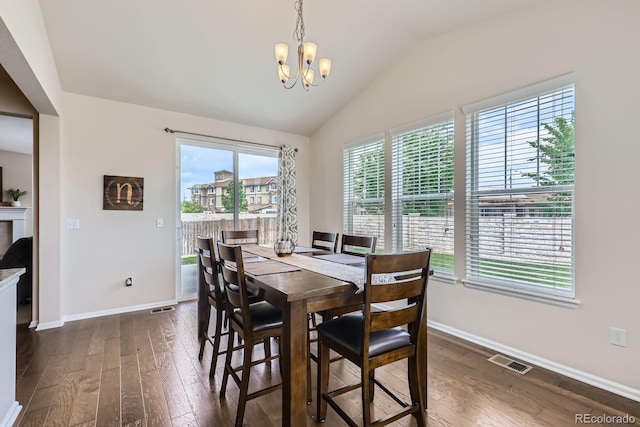 12578 Hudson Ct, Thornton, CO 80241 - dining space with dark wood-style flooring, a chandelier, baseboards, and vaulted ceiling