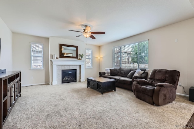 12578 Hudson Ct, Thornton, CO 80241 - living room featuring healthy amount of natural light, ceiling fan, light colored carpet, and a tiled fireplace