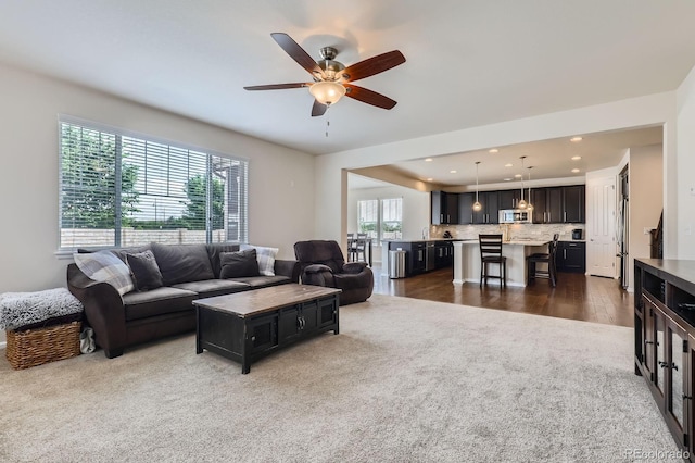 12578 Hudson Ct, Thornton, CO 80241 - living area with dark colored carpet, ceiling fan, and recessed lighting