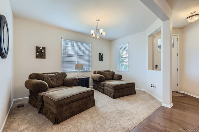 12578 Hudson Ct, Thornton, CO 80241 - living room with a chandelier, baseboards, and dark wood-style flooring