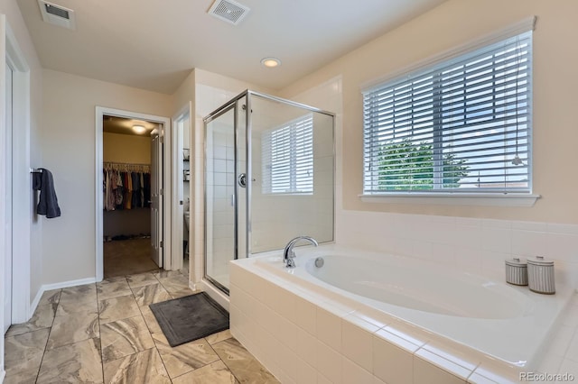 12578 Hudson Ct, Thornton, CO 80241 - full bath with a bath, a stall shower, a walk in closet, and marble finish floors