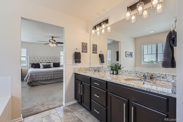12578 Hudson Ct, Thornton, CO 80241 - full bathroom featuring double vanity, ensuite bathroom, marble look tile flooring, and a ceiling fan