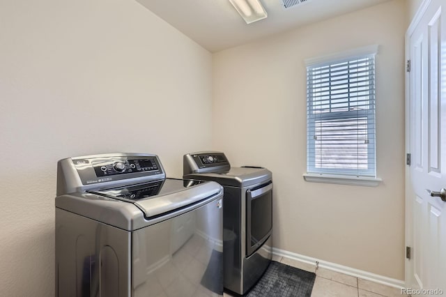 12578 Hudson Ct, Thornton, CO 80241 - laundry room featuring independent washer and dryer, light tile patterned flooring, and baseboards