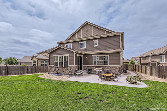12578 Hudson Ct, Thornton, CO 80241 - rear view of house with stone siding and a patio