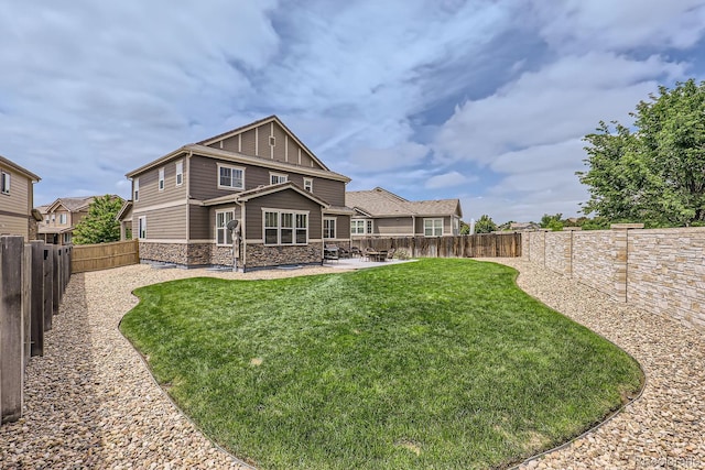12578 Hudson Ct, Thornton, CO 80241 - rear view of property featuring stone siding and a patio