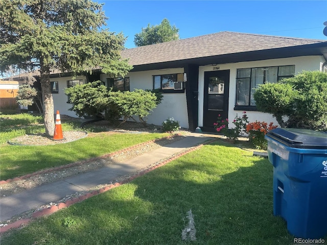 6671 E 73rd Pl, Commerce City, CO 80022 - view of front of home featuring a shingled roof, a front lawn, and stucco siding