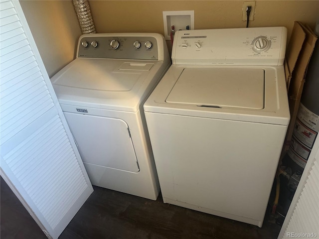 6671 E 73rd Pl, Commerce City, CO 80022 - laundry area featuring independent washer and dryer, water heater, and dark wood-type flooring