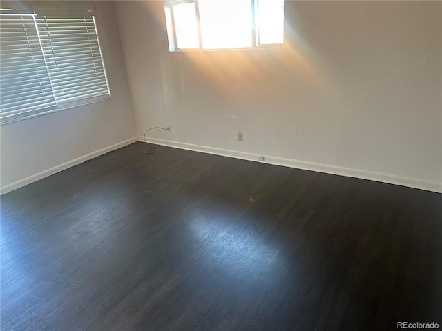 6671 E 73rd Pl, Commerce City, CO 80022 - spare room featuring baseboards and dark wood-style floors