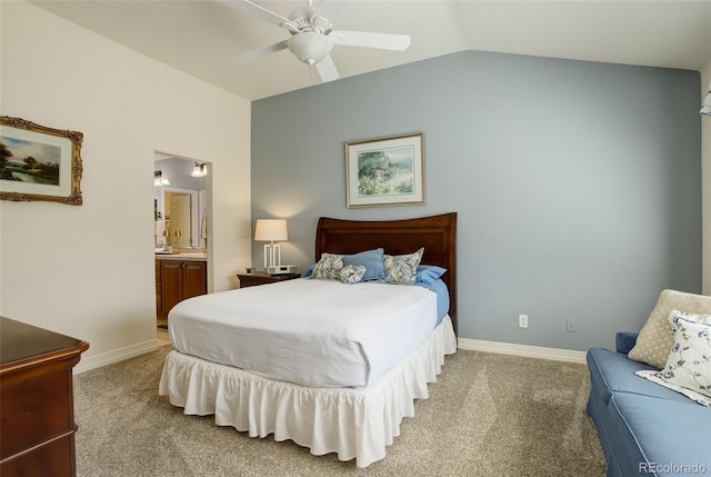 bedroom featuring baseboards, vaulted ceiling, carpet, and ensuite bath