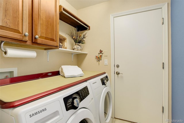 clothes washing area with independent washer and dryer and cabinet space