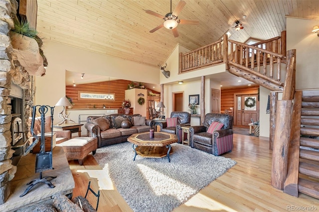 living area with wood ceiling, ceiling fan, stairs, light wood-style floors, and high vaulted ceiling