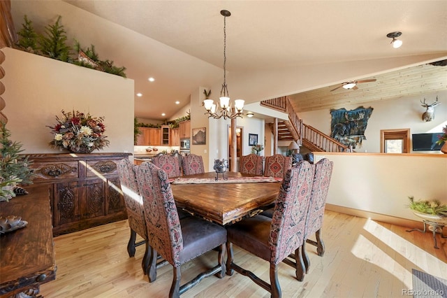 dining room with lofted ceiling, light wood finished floors, stairs, and recessed lighting