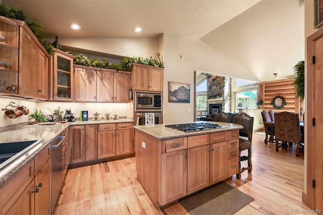 kitchen with log walls, stainless steel appliances, light wood-type flooring, and glass insert cabinets