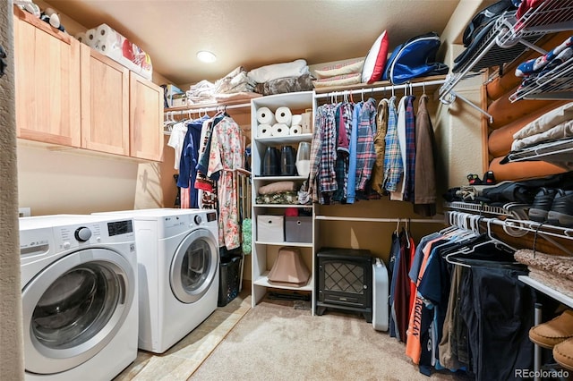 laundry area with separate washer and dryer, cabinet space, and light colored carpet