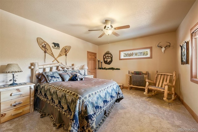 bedroom with a ceiling fan, light colored carpet, a textured ceiling, and baseboards