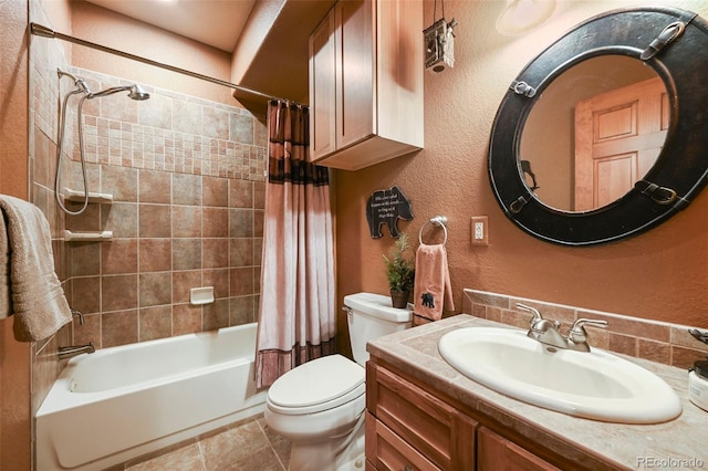 full bathroom with a textured wall, tile patterned flooring, toilet, shower / tub combo, and vanity