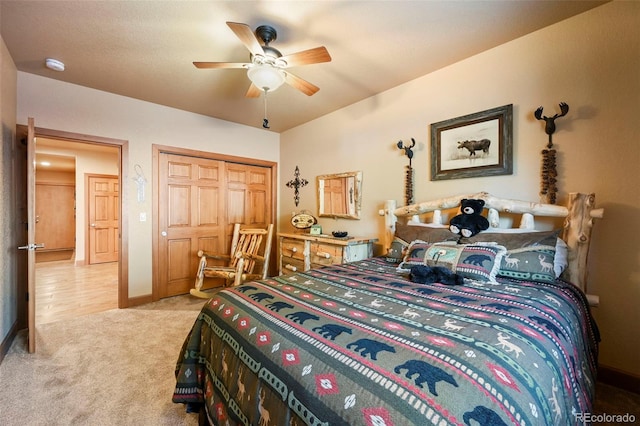 bedroom with ceiling fan, baseboards, a closet, and light colored carpet