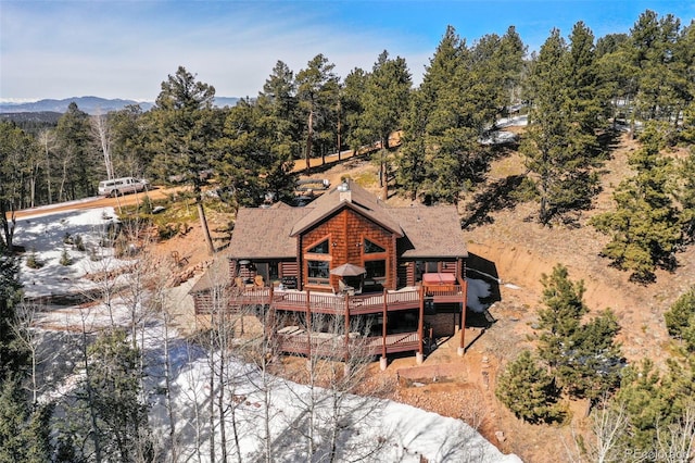 rear view of property with a chimney and a wooden deck