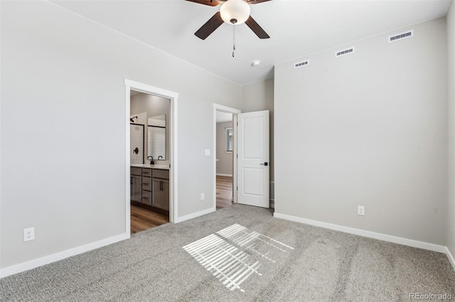 unfurnished bedroom with visible vents, baseboards, and carpet