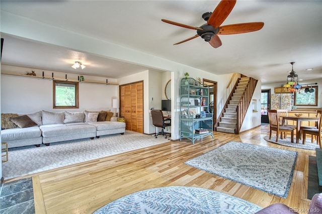 living room with ceiling fan and light hardwood / wood-style flooring