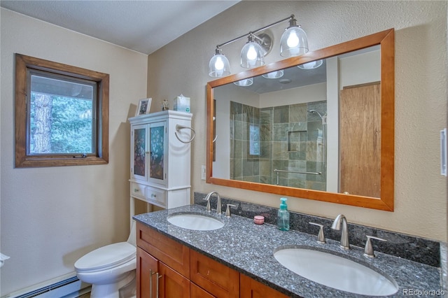 bathroom featuring vanity, toilet, baseboard heating, and walk in shower