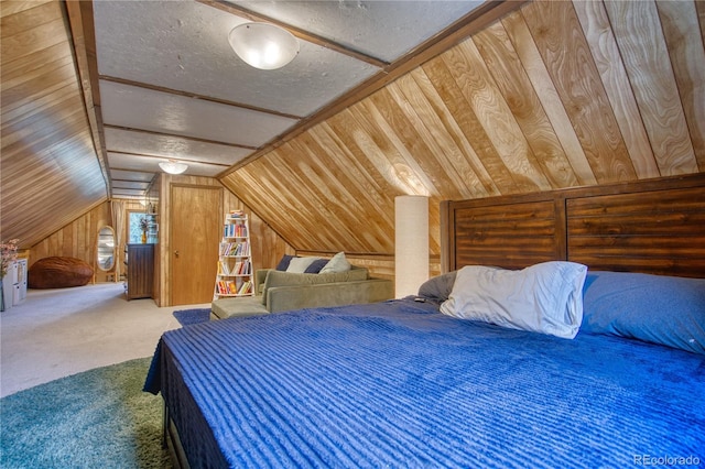 carpeted bedroom with vaulted ceiling, a textured ceiling, and wood walls