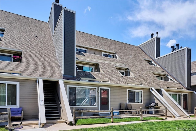 5250 S Huron Way Unit 5-308, Littleton, CO 80120 - rear view of property with stairs, a chimney, and a shingled roof