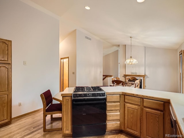 9670 W 69th Ave, Arvada, CO 80004 - kitchen with black range with gas stovetop, light wood-style floors, light countertops, lofted ceiling, and baseboards