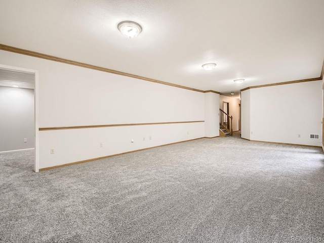 9670 W 69th Ave, Arvada, CO 80004 - unfurnished room featuring crown molding, carpet flooring, baseboards, and stairway