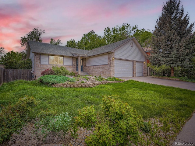 9670 W 69th Ave, Arvada, CO 80004 - view of front facade with brick siding, an attached garage, and concrete driveway