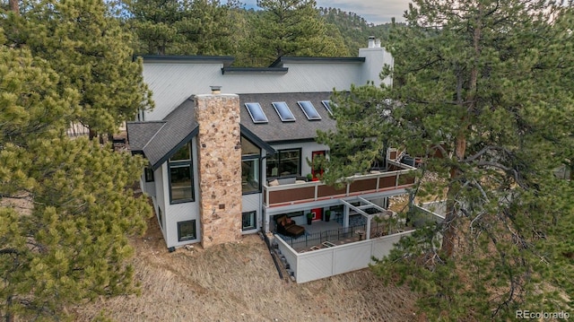 1854 Foothills Dr S, Golden, CO 80401 - rear view of property featuring roof with shingles and a chimney