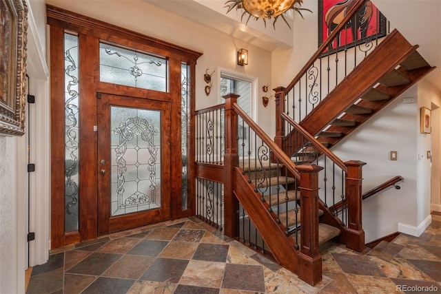 1854 Foothills Dr S, Golden, CO 80401 - entrance foyer featuring stairs, stone tile floors, and baseboards