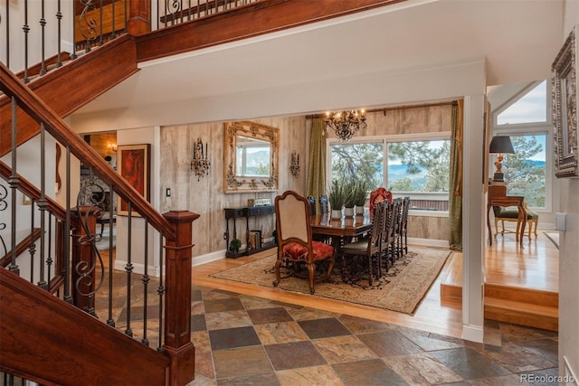 1854 Foothills Dr S, Golden, CO 80401 - dining area with an inviting chandelier, stone finish flooring, a high ceiling, stairs, and baseboards