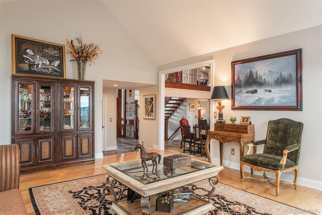 1854 Foothills Dr S, Golden, CO 80401 - living area with light wood-style flooring, stairway, high vaulted ceiling, and baseboards