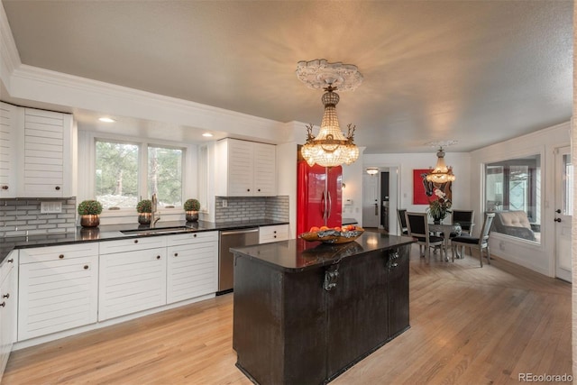 1854 Foothills Dr S, Golden, CO 80401 - kitchen featuring plenty of natural light, an inviting chandelier, a sink, dark countertops, and stainless steel dishwasher