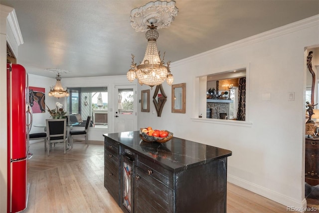 1854 Foothills Dr S, Golden, CO 80401 - kitchen with ornamental molding, light wood-type flooring, freestanding refrigerator, and a notable chandelier