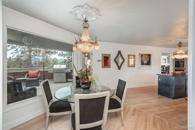 1854 Foothills Dr S, Golden, CO 80401 - dining area featuring baseboards, light wood-type flooring, and an inviting chandelier