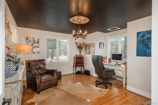 1854 Foothills Dr S, Golden, CO 80401 - office area with baseboards, light wood-type flooring, a notable chandelier, and visible vents
