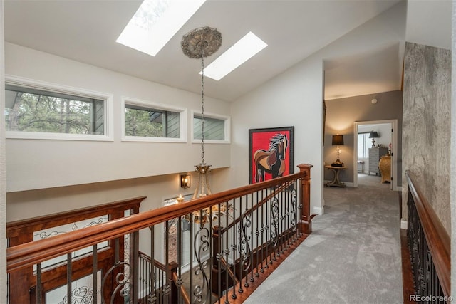 1854 Foothills Dr S, Golden, CO 80401 - corridor featuring vaulted ceiling with skylight, carpet flooring, baseboards, and an upstairs landing