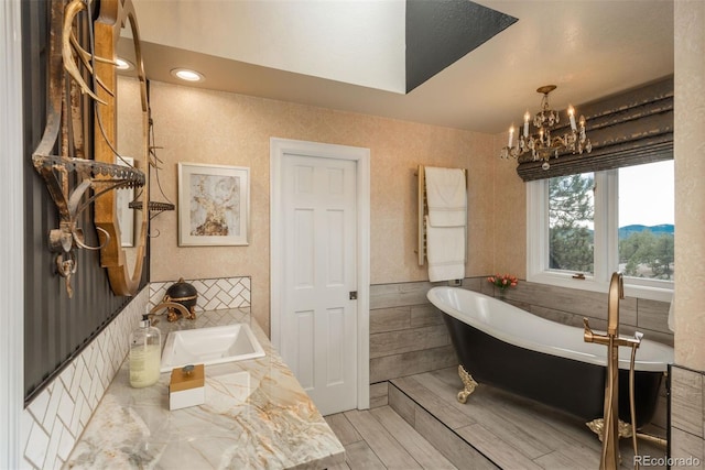 1854 Foothills Dr S, Golden, CO 80401 - full bathroom featuring a sink, a freestanding tub, a chandelier, and wood finished floors