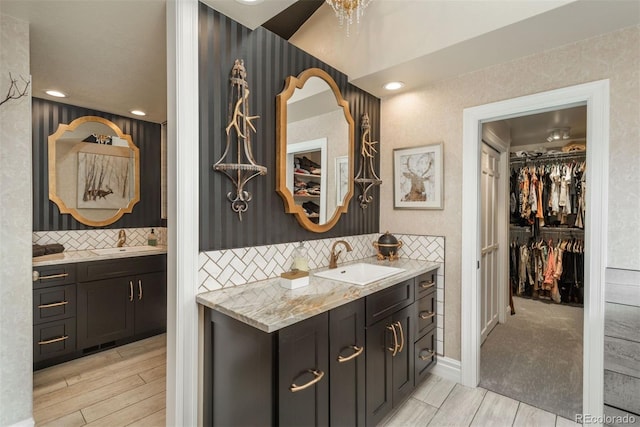 1854 Foothills Dr S, Golden, CO 80401 - full bath with two vanities, wood finish floors, a sink, and a walk in closet