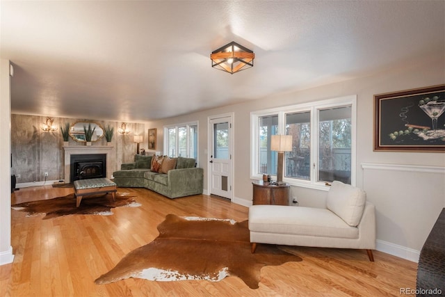 1854 Foothills Dr S, Golden, CO 80401 - living area with a wealth of natural light, a fireplace with raised hearth, wood finished floors, and baseboards