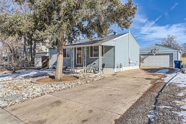 view of front of home featuring an outbuilding, a garage, and covered porch