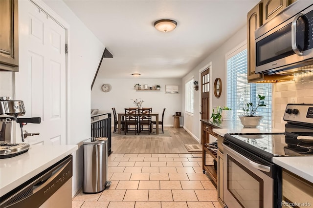 kitchen featuring stainless steel appliances and light tile patterned floors